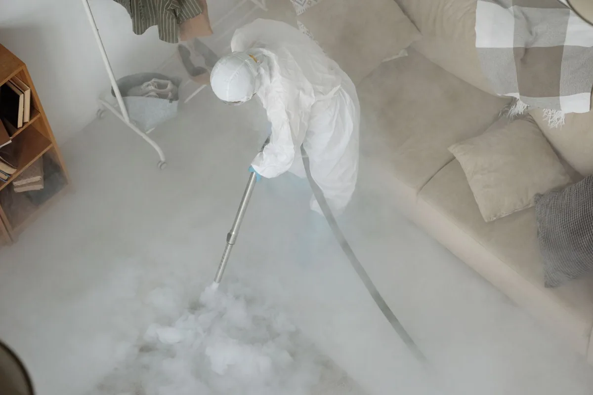 Biohazard cleanup technician in protective equipment, Lake Brownwood, TX